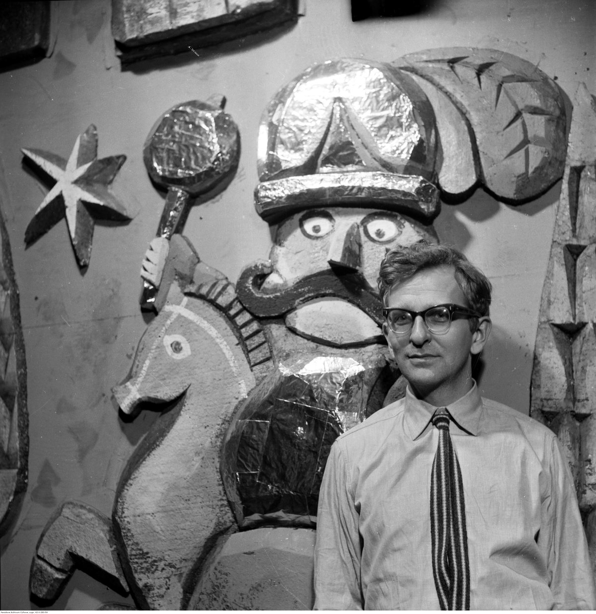 Adam Kilian scenographer standing in front of stage decoration for the play Pastorałka at Teatr Powszechny in Warsaw