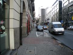 View of Piękna Street in Warsaw with historic buildings and trees
