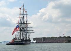 USS Constitution firing a 21-gun salute toward Fort Independence on Castle Island during Boston Navy Week