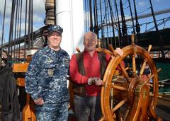 Buzz Aldrin at the helm of USS Constitution during a tour with Cmdr. Sean Kearns