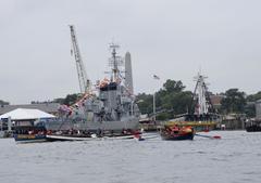 Chief Petty Officer Selectees rowing in a competition during Chief Petty Officer Heritage Week aboard USS Constitution in Boston