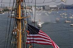 U.S. Coast Guard Cutter Eagle sailing in Boston Harbor escorted by law-enforcement vessels on July 4, 2012