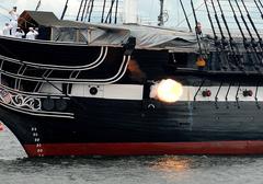USS Constitution firing portside cannon during 21-gun salute in Boston Harbor on July 4th