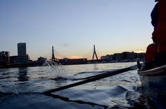 Chief Petty Officer Selectees rowing a Cornish Gig boat during Chief Petty Officer Heritage Week aboard USS Constitution in Boston