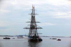 USS Constitution firing a 21-gun salute near Fort Independence during Independence Day demonstration