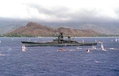 USS Missouri battleship being towed past Diamond Head towards Pearl Harbor