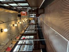 Interior of a vintage tramway with wooden seats and metal handrails