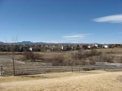 Houses in northeastern Westminster, Colorado with the Rocky Mountains and Longs Peak in the background under a partly cloudy sky