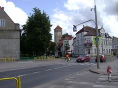 Historic street in Szczytno, Poland with cobblestone pavement and traditional architecture