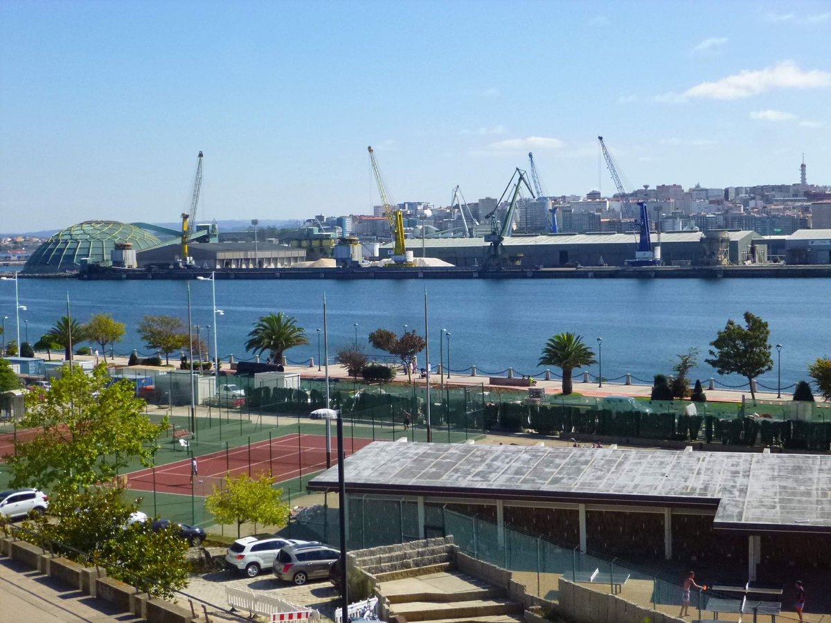 Panoramic view of A Coruña city with Tower of Hercules lighthouse at sunset