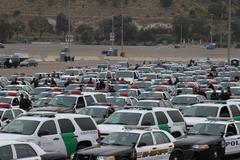 Funeral procession vehicles for Officer Jeremy Henwood parked at Qualcomm Stadium