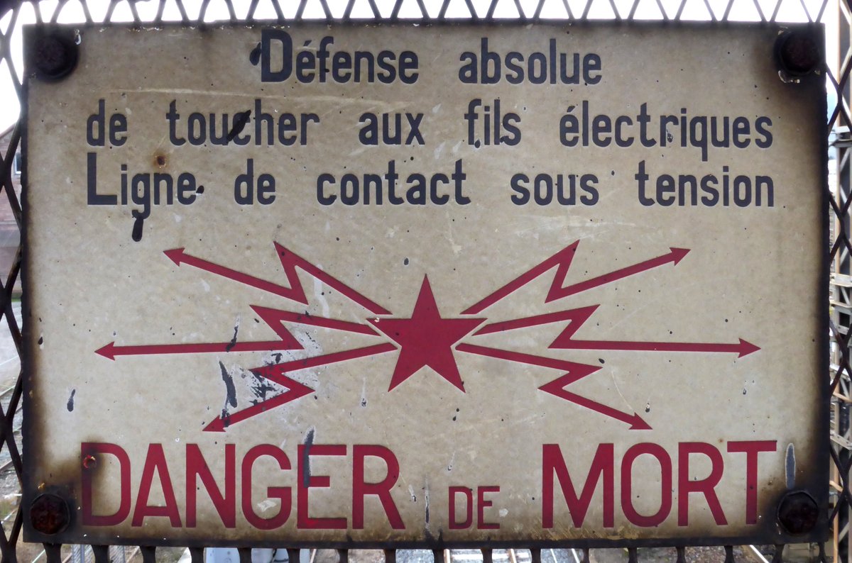 High voltage warning sign on a railway bridge in Colmar