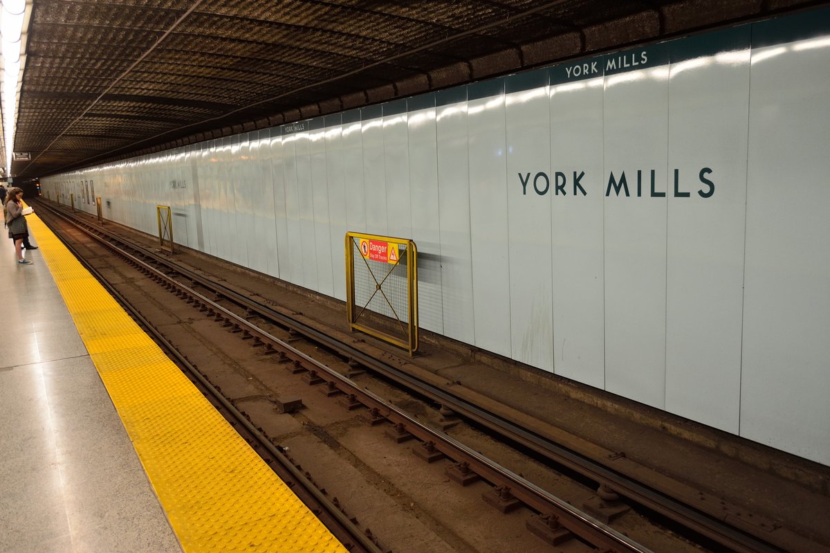 York Mills TTC subway station platform with trains and signage