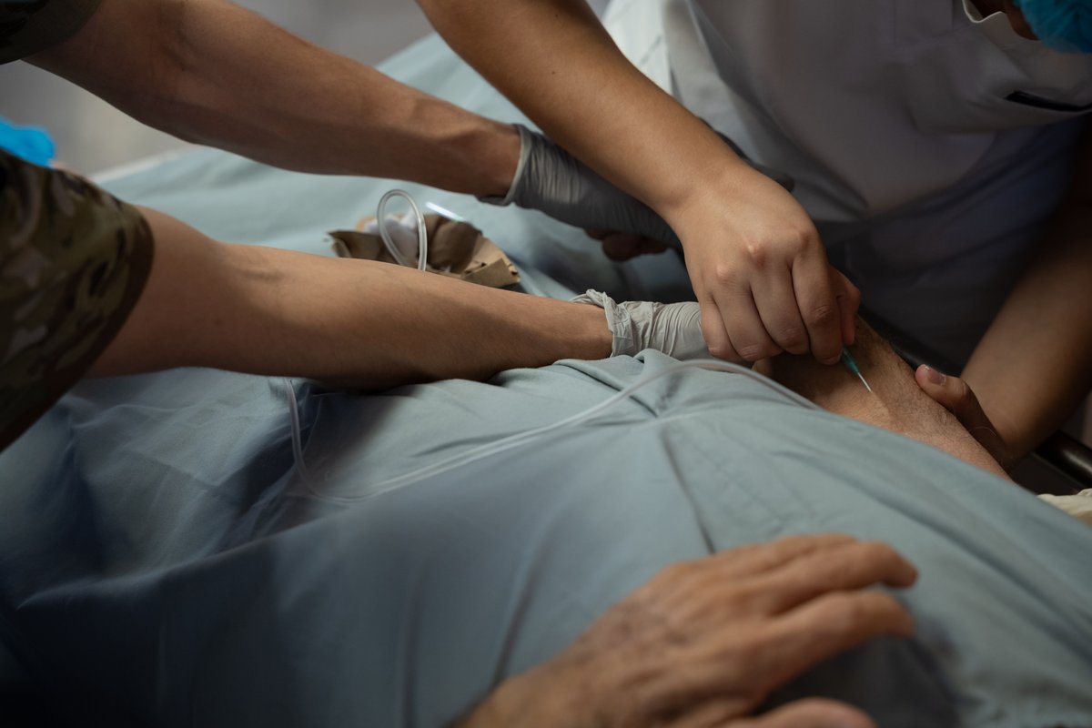 U.S. Air Force nurse and local nurse providing medical aid to a patient at San Bartolo National Hospital in El Salvador during AMISTAD 2025