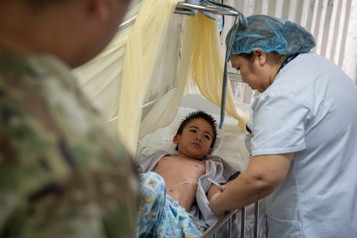 Local nurse caring for child at San Bartolo National Hospital, El Salvador, June 2025