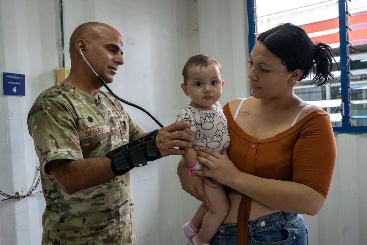 U.S. Air Force medical personnel examining a baby at San Bartolo National Hospital in El Salvador during AMISTAD 2025