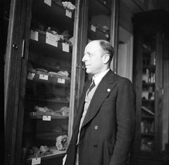 Professor Imbo standing next to a cabinet with stones at the Vesuvius Observatory in Naples, Italy, in 1938