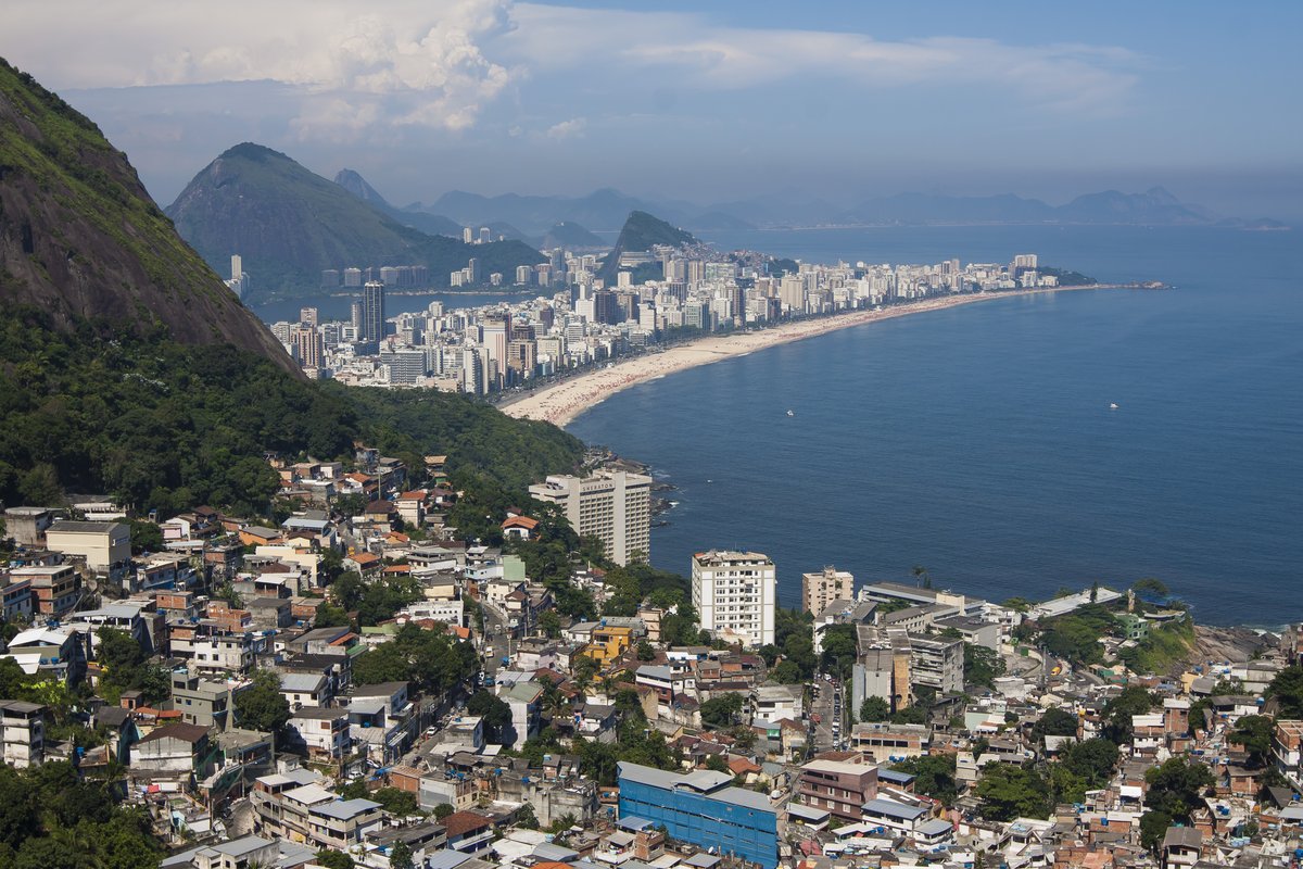 Scenic view of Ipanema beach in Rio de Janeiro with mountains and vibrant sky