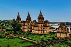 16th to 18th century Bundela Chhatris funerary monuments in Orchha, Madhya Pradesh, India featuring multistoried structures with domed canopies and Hindu-Mughal architectural fusion along the Betwa River