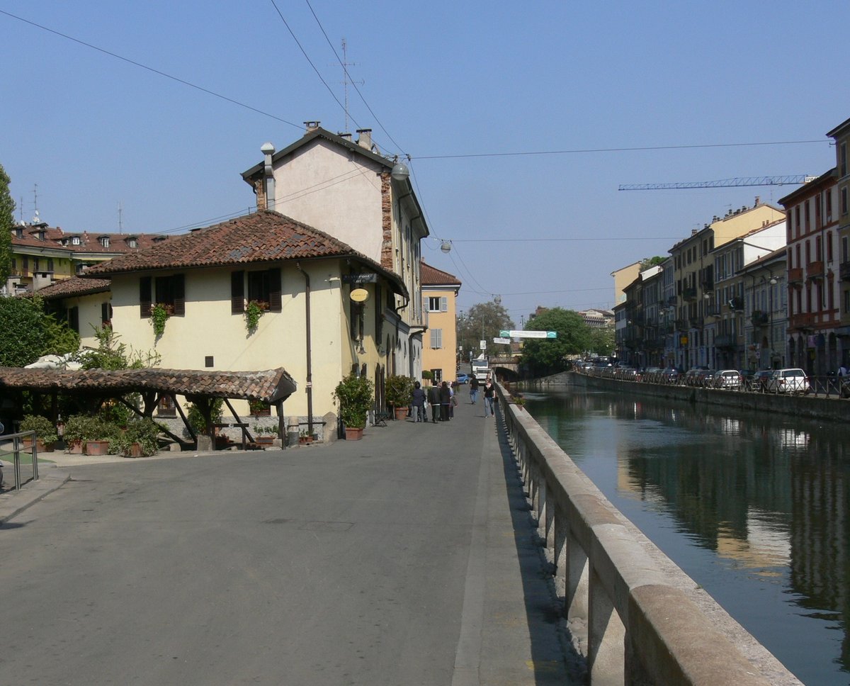 Naviglio canal in Milan with historic buildings and boats
