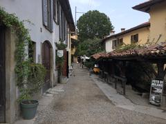 View of a narrow alley with a historic washing place on the right in Milan, Italy