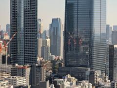 Azabudai Hills on opening day showcasing modern skyscrapers and lush green rooftop gardens in Tokyo