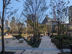 Azabudai Hills complex on opening day with modern buildings and greenery in Tokyo