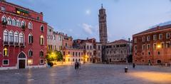 Santo Stefano church in Venice lit at dusk with canal and buildings