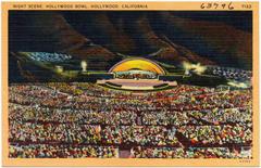 Night scene at Hollywood Bowl with illuminated stage and audience under dark sky in Hollywood California