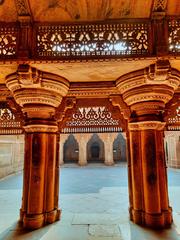 Man Singh Palace at Gwalior Fort, intricately carved sandstone palace with colorful upper floors, historical Hindu king's palace