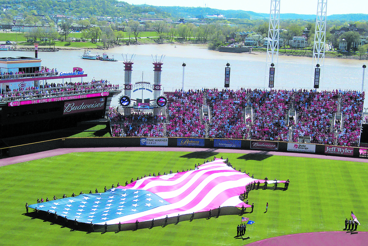 85 Wright-Patterson AFB members holding American flag during national anthem at Cincinnati Reds-Chicago Cubs opening day baseball game