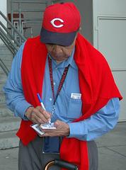 Chuck Harmon signing an autograph at Cincinnati Reds game with Navy personnel