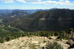 View of Rainbow Curve on Trail Ridge Road near Beaver Meadow with mountainous landscape and trees