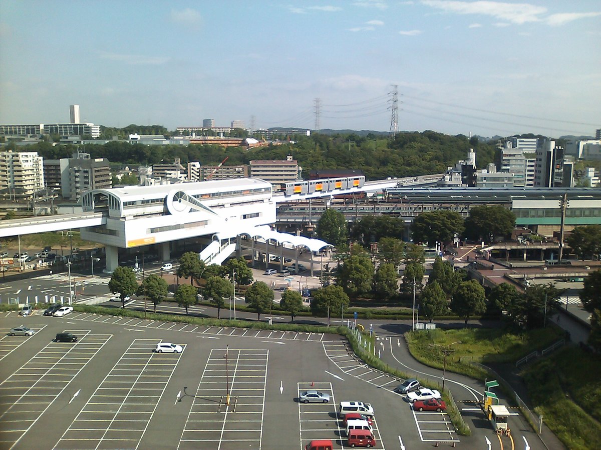 Bird's eye view of Tama Centre stations from the public parking lot showing rail tracks and surrounding buildings