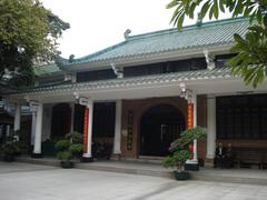 Huaisheng Mosque in Guangzhou, China with green minaret under blue sky