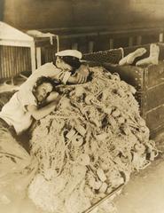 Boys sleeping on idle fishing nets in Riviera Beach Florida in May 1939