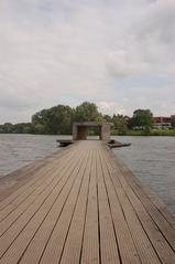 Pier on Aasee lake in Münster with reflections on water