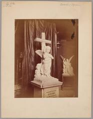 Sculptures in Bolesław Syrewicz's studio at the Royal Castle in Warsaw featuring a white marble child's angel grave monument with raised hand and a cross from 1876
