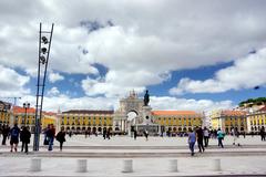 Crowded Praça do Comércio square in Lisbon, Portugal, bustling with people walking and enjoying the historic outdoor space